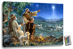 This stunning piece features three generations of shepherds gathered around a cozy fire, with a sweet lamb by their side. As they tend to their flock in the peaceful countryside, one of the wise shepherds points towards a shining star that illuminates the night sky, leading the way to the birthplace of Jesus.