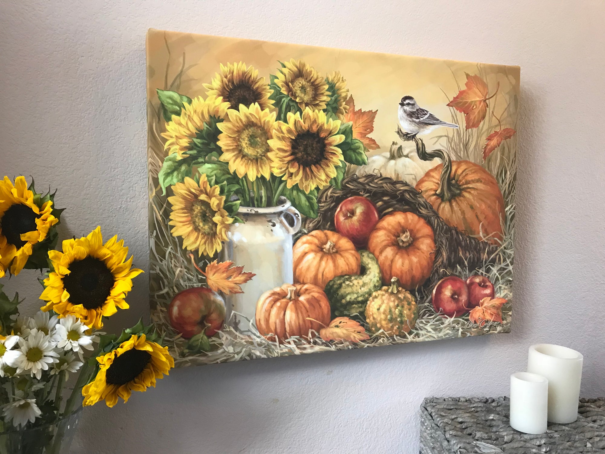 The warm hues of sunflowers sitting in an old fashioned milk jug will fill your heart with joy and nostalgia. Pumpkins, gourds, and apples surround the centerpiece, creating a wholesome and inviting atmosphere.